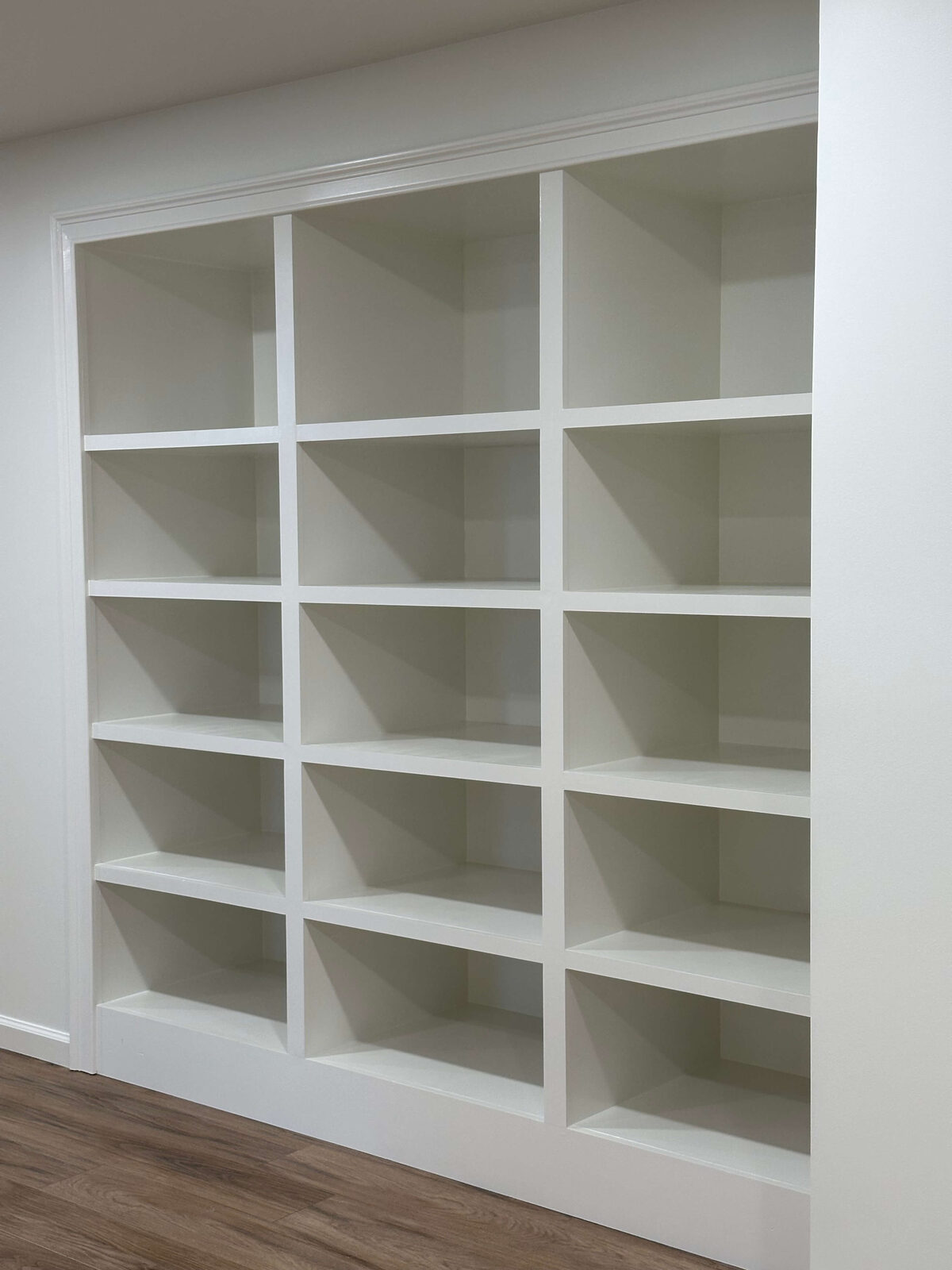 Custom built-in cubby shelving in basement living area