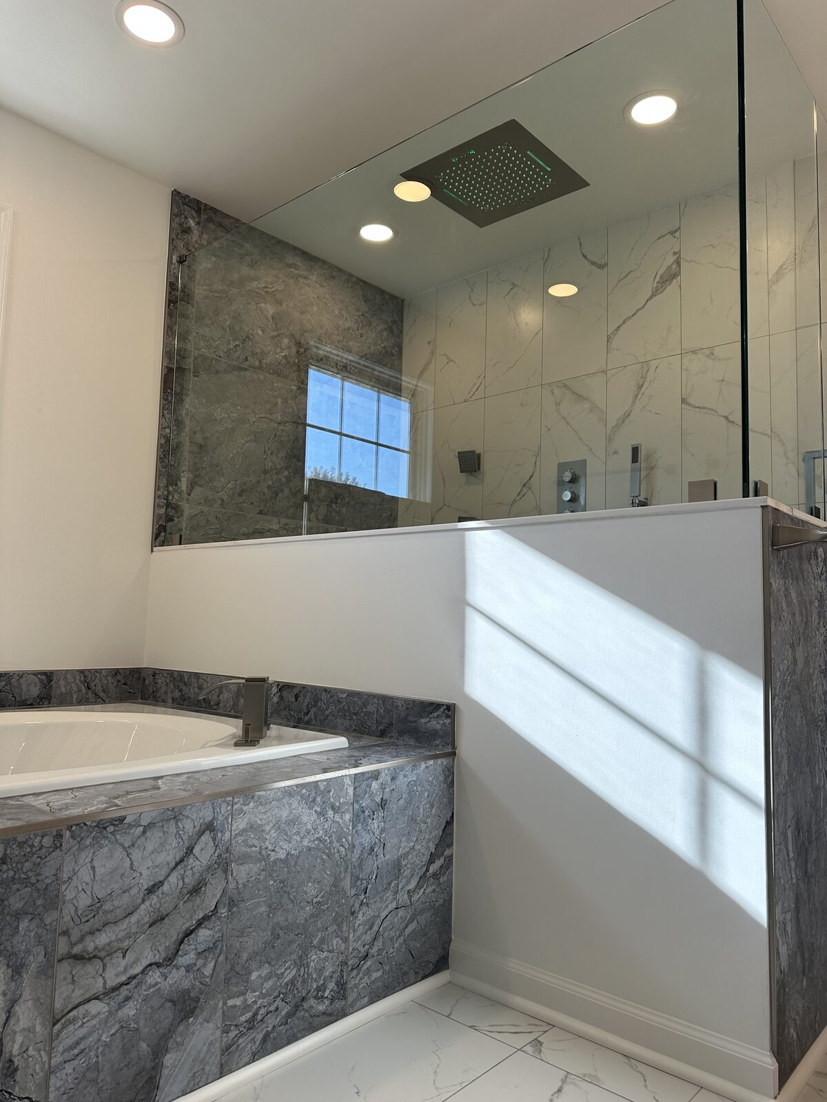 Built-in soaking tub deck with grey marble surround