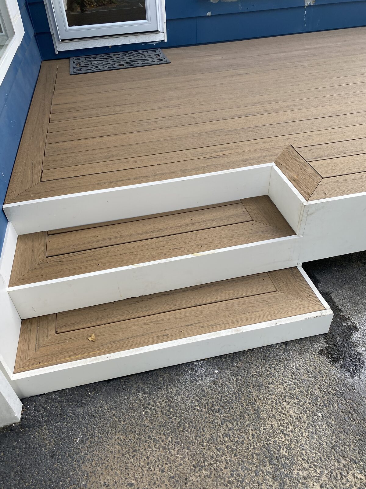 Composite deck steps with white PVC risers and matching trim
