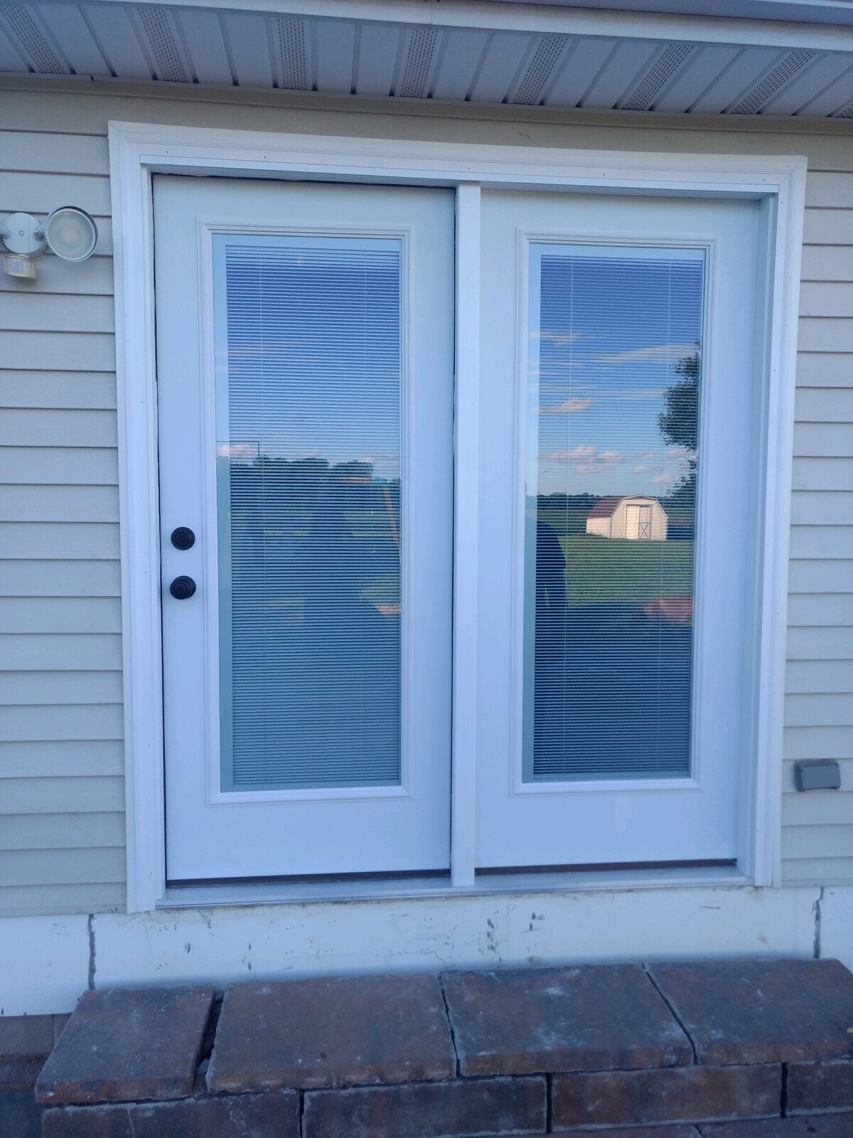 Exterior French double doors with built-in blinds