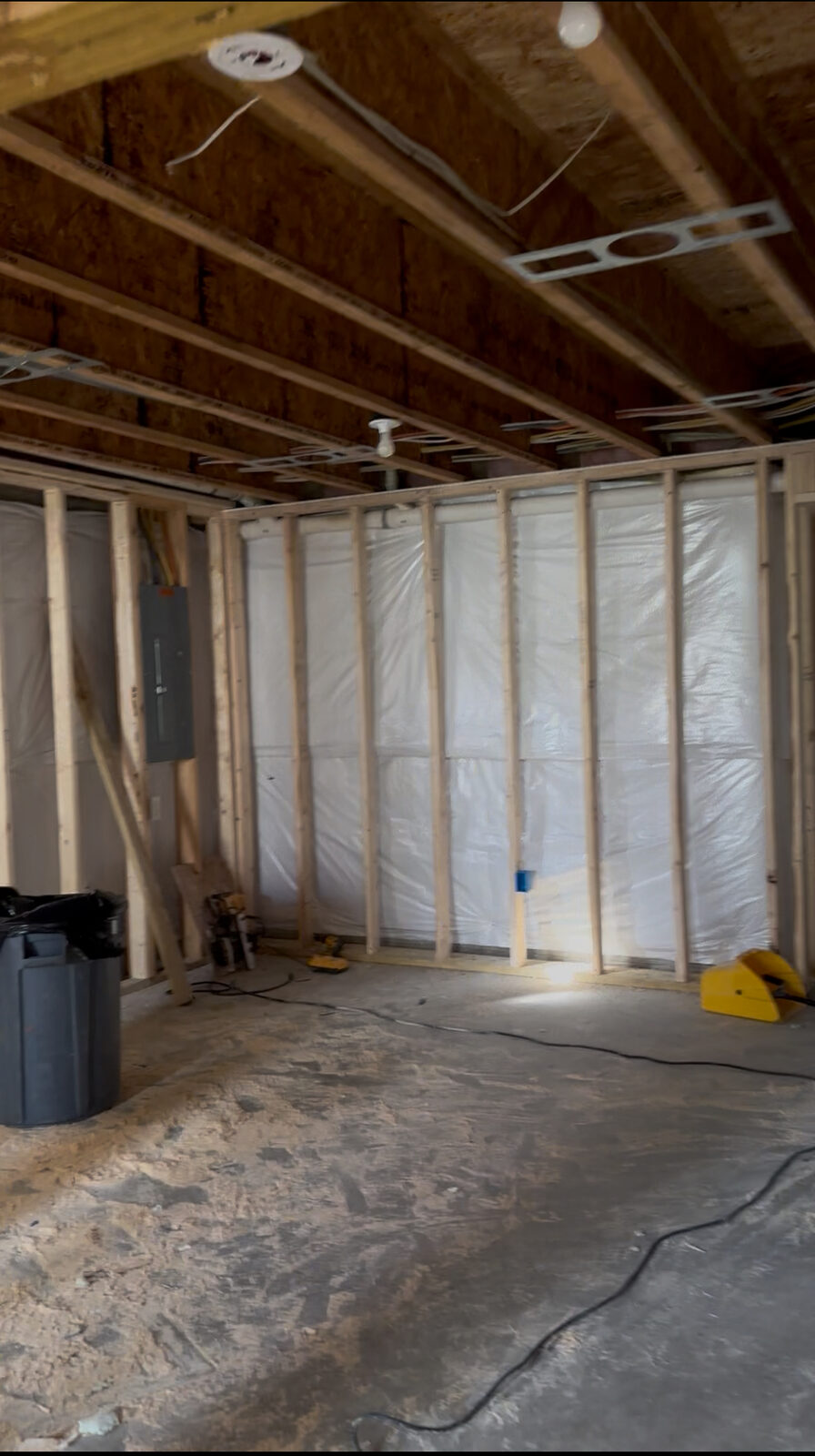 Basement framing with vapor barrier and electrical panel