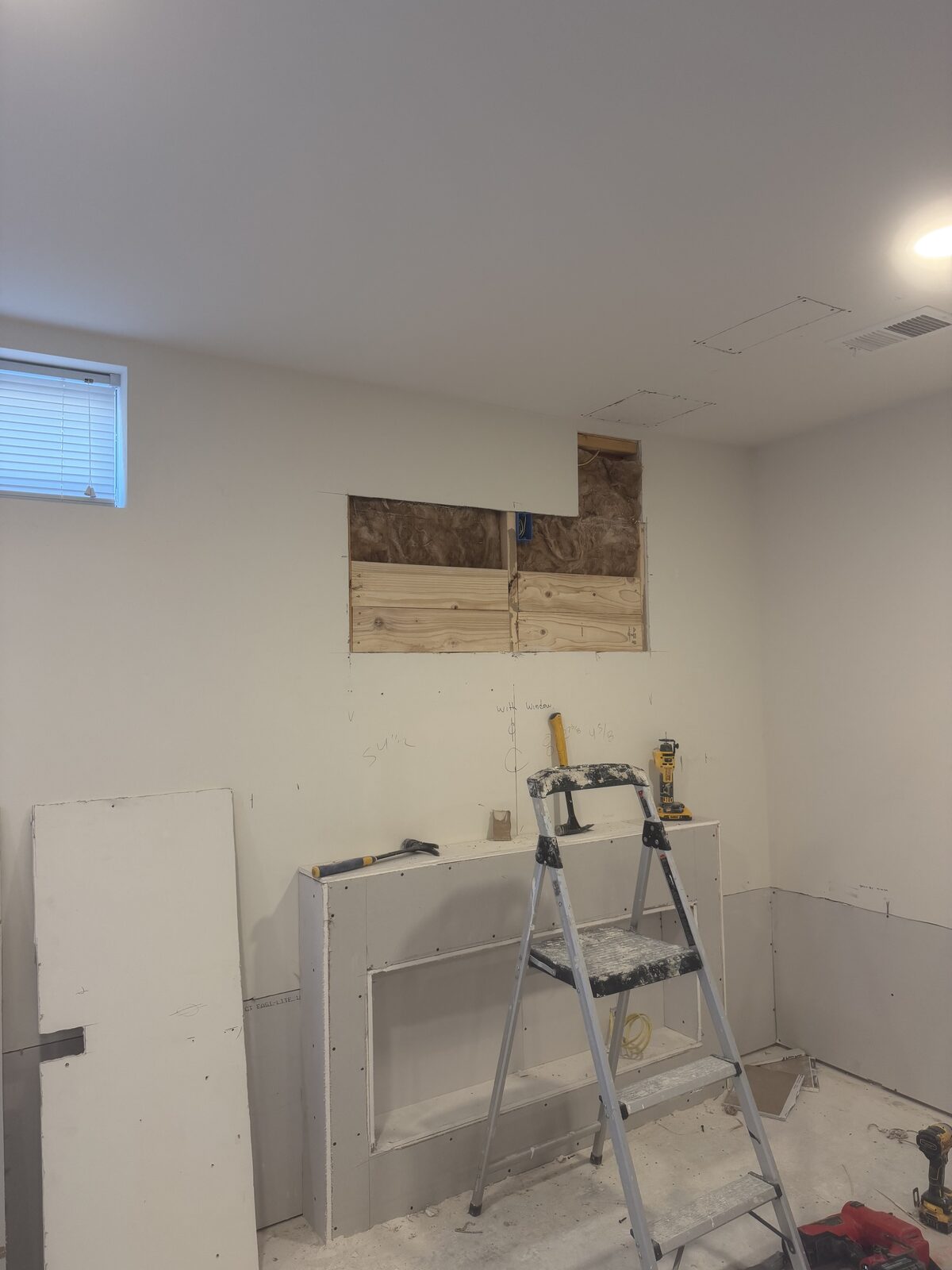 Drywall installation in progress with framed wall niche