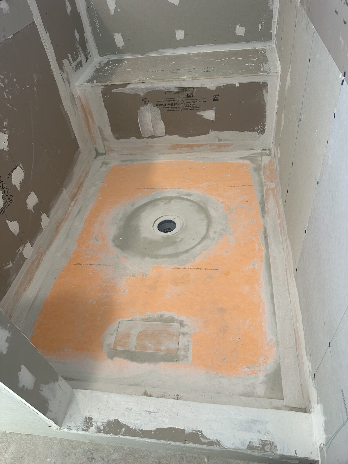 Schluter Kerdi orange waterproofing membrane on shower pan
