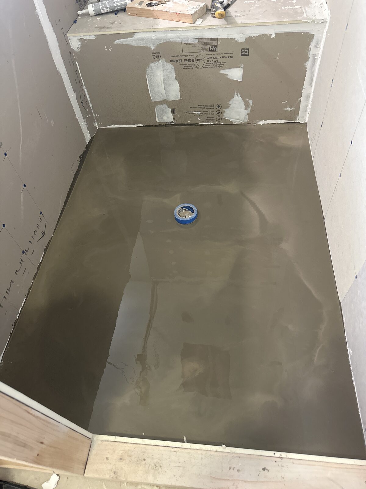 Smooth troweled mortar bed shower pan ready for tile