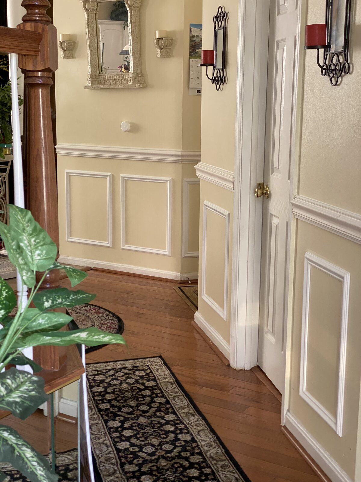 Custom wainscoting and picture frame trim in entryway hallway